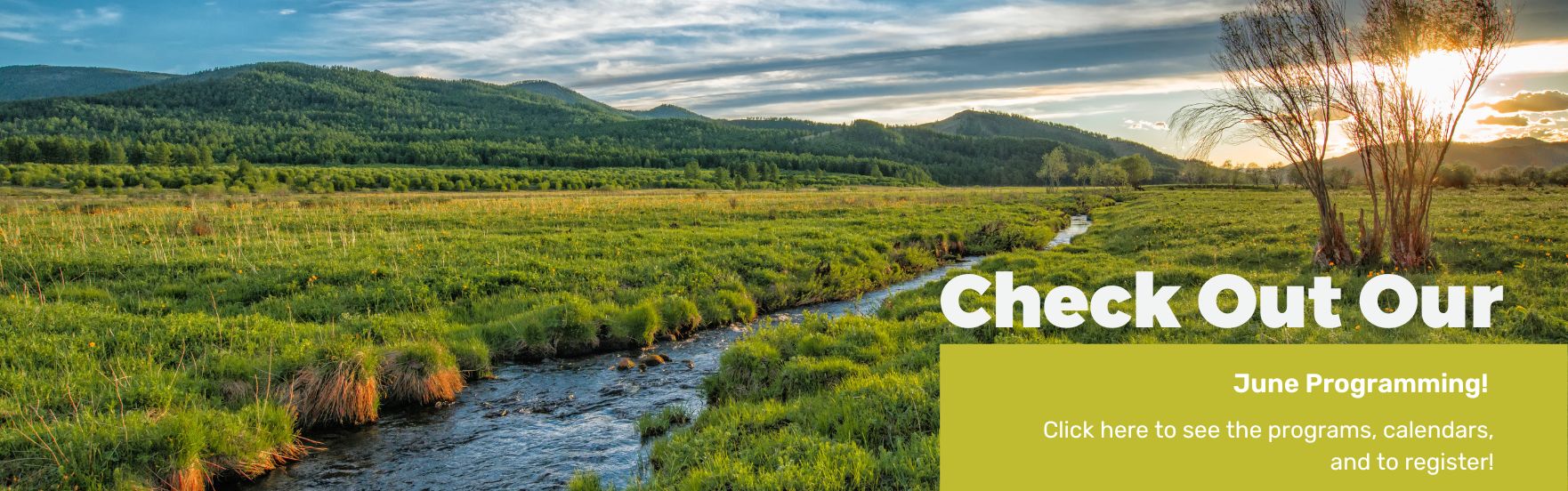A creek running through a valley with text advertising to click for june programs.